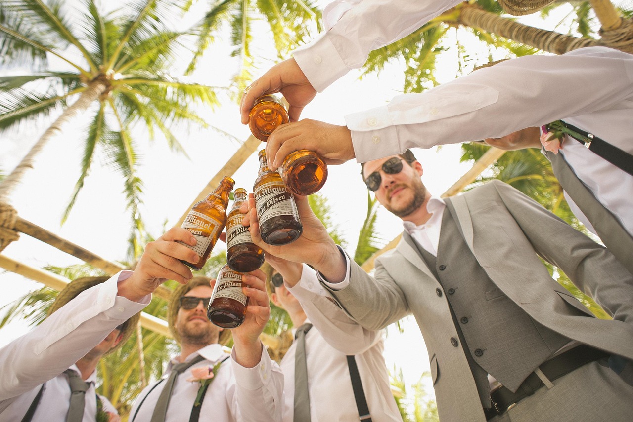 men, beers, cheers, toast, bottles, beer bottles, wedding, groom, groomsmen, group, friends, friendship, brotherhood, suits, suit and tie, formal attire, wedding photography, wedding celebration, celebrate, event, bearded men, adults, alcoholic beverages, celebration, formal coat, happy, outdoors, palm trees, people, men, cheers, wedding, friends, friends, friends, friends, friends, friendship, event